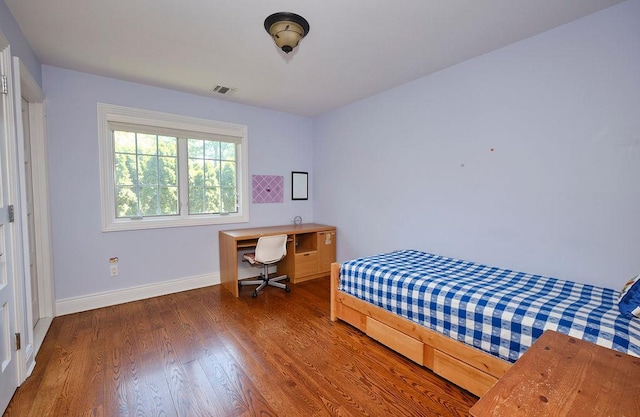 23 Tanners Rd, Great Neck, NY 11020 - bedroom with wood finished floors, baseboards, and an office area