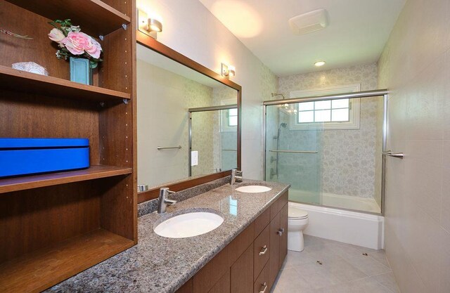 23 Tanners Rd, Great Neck, NY 11020 - full bathroom featuring toilet, double vanity, enclosed tub / shower combo, and tile patterned floors