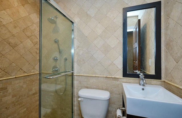 23 Tanners Rd, Great Neck, NY 11020 - bathroom with tile walls, a shower stall, toilet, and a sink
