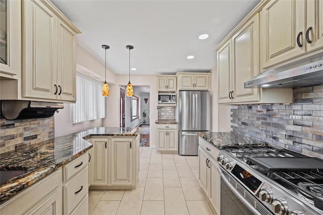 15 Salem Rd, Hicksville, NY 11801 - kitchen featuring cream cabinets, appliances with stainless steel finishes, tasteful backsplash, dark stone counters, and under cabinet range hood