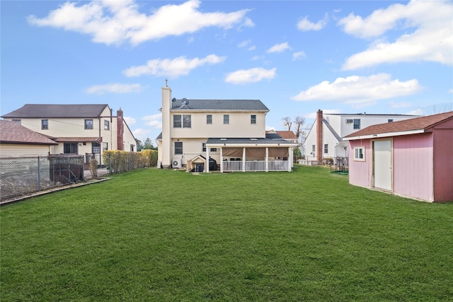 15 Salem Rd, Hicksville, NY 11801 - rear view of house featuring a sunroom, a fenced backyard, a chimney, and a shed