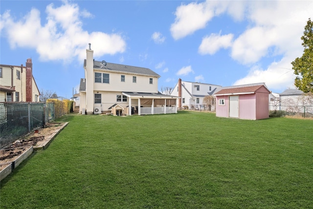 15 Salem Rd, Hicksville, NY 11801 - back of house with a sunroom, a shed, a fenced backyard, and a chimney