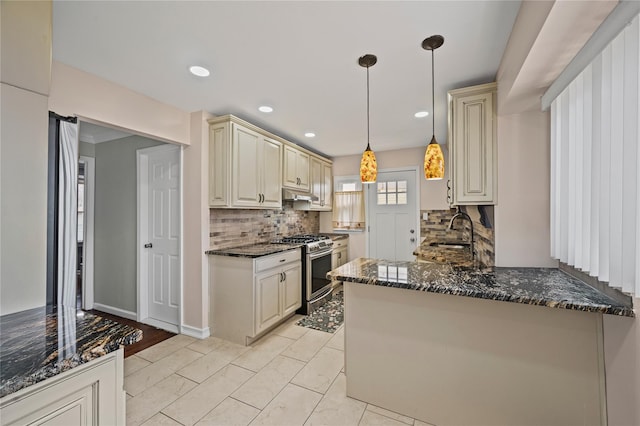 15 Salem Rd, Hicksville, NY 11801 - kitchen featuring stainless steel gas range oven, cream cabinetry, tasteful backsplash, under cabinet range hood, and dark stone countertops