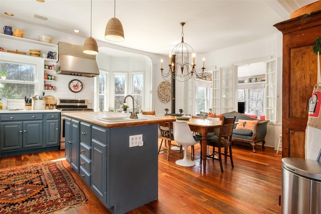 336 County Highway 5, Bovina Center, NY 13740 - kitchen with exhaust hood, a sink, a chandelier, stainless steel range with gas stovetop, and gray cabinetry