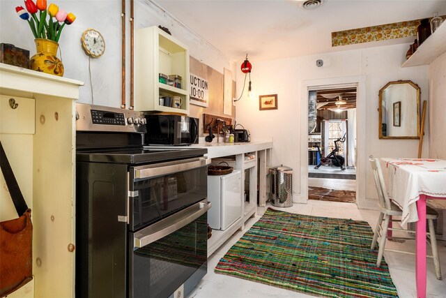 336 County Highway 5, Bovina Center, NY 13740 - kitchen with double oven range, black microwave, and open shelves