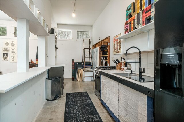 336 County Highway 5, Bovina Center, NY 13740 - kitchen featuring open shelves, stainless steel range with gas cooktop, a sink, concrete floors, and plenty of natural light