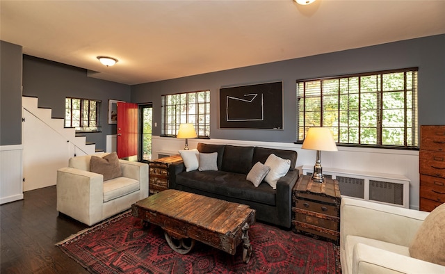 87 River Rd, Nyack, NY 10960 - living area with dark wood-style floors, stairway, wainscoting, and radiator heating unit