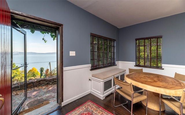 87 River Rd, Nyack, NY 10960 - dining room featuring wainscoting, dark wood-style flooring, and a water view