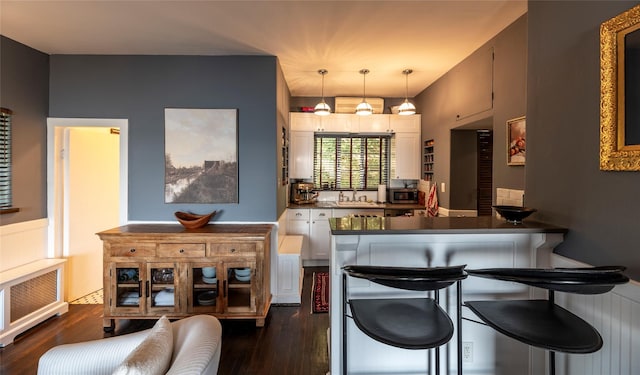 87 River Rd, Nyack, NY 10960 - kitchen with dark countertops, radiator, a peninsula, and dark wood-style floors