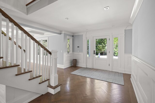 8 E Huxley Dr, Lloyd Harbor, NY 11743 - foyer with a decorative wall, a wainscoted wall, stairs, and crown molding