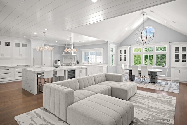 8 E Huxley Dr, Lloyd Harbor, NY 11743 - living area with a chandelier, beverage cooler, dark wood-style floors, lofted ceiling, and recessed lighting