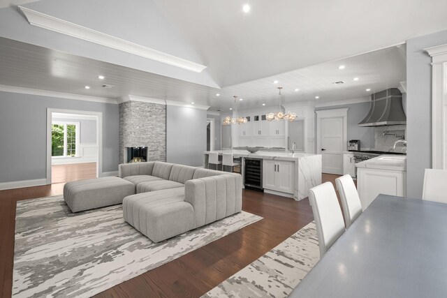 8 E Huxley Dr, Lloyd Harbor, NY 11743 - living room featuring wine cooler, a chandelier, recessed lighting, dark wood finished floors, and lofted ceiling