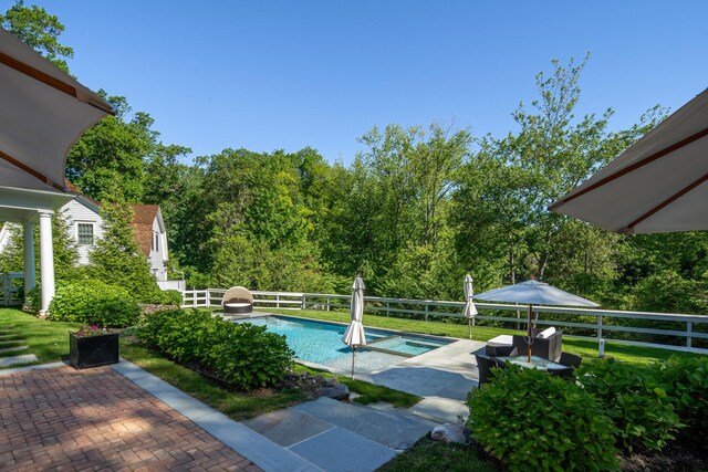 8 E Huxley Dr, Lloyd Harbor, NY 11743 - view of swimming pool with a patio area, a pool with connected hot tub, a water slide, and a yard