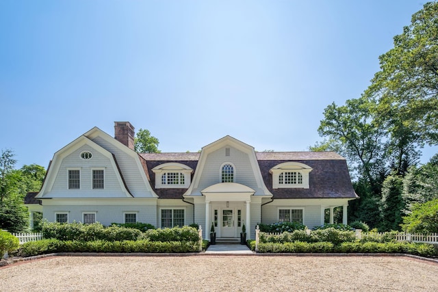 8 E Huxley Dr, Lloyd Harbor, NY 11743 - shingle-style home with a gambrel roof, a shingled roof, and a chimney