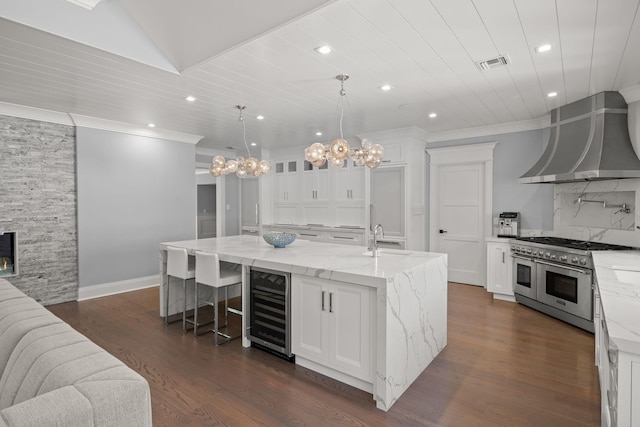 8 E Huxley Dr, Lloyd Harbor, NY 11743 - kitchen featuring double oven range, wine cooler, white cabinetry, recessed lighting, and ornamental molding
