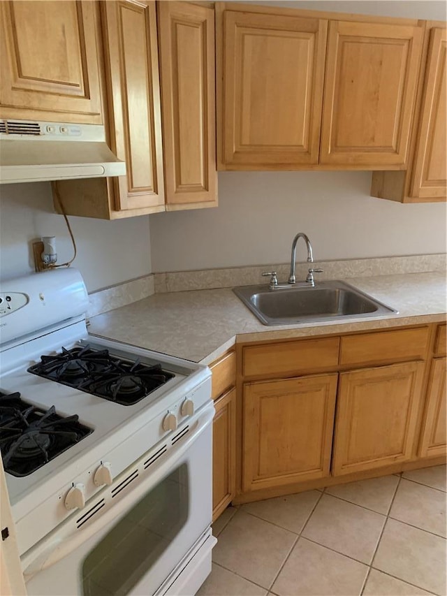 30 Davenport Ave Unit 1L, New Rochelle, NY 10805 - kitchen with white gas range oven, under cabinet range hood, a sink, and light countertops