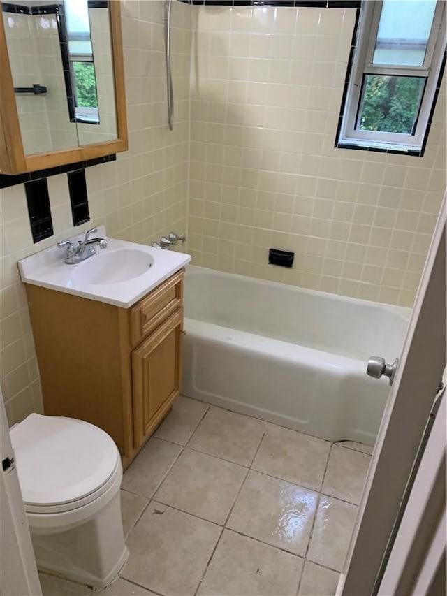 30 Davenport Ave Unit 1L, New Rochelle, NY 10805 - bathroom featuring toilet, vanity, tile patterned flooring,  shower combination, and tile walls