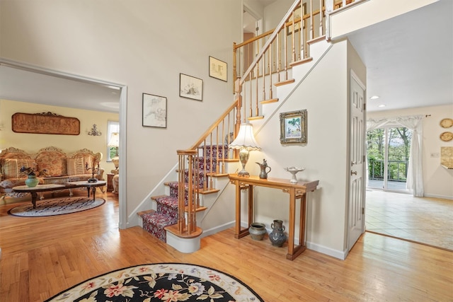 57 Wilner Rd, Somers, NY 10589 - stairway featuring wood finished floors, a high ceiling, and baseboards