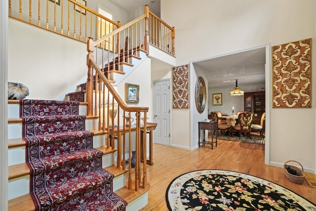 57 Wilner Rd, Somers, NY 10589 - staircase with wood finished floors, baseboards, and a towering ceiling