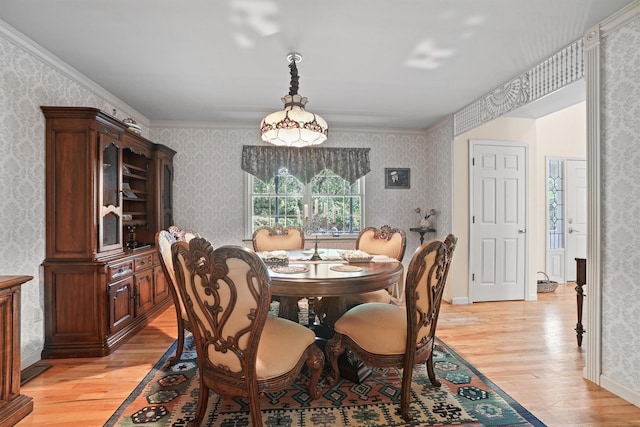 57 Wilner Rd, Somers, NY 10589 - dining space featuring light wood-style flooring, wallpapered walls, baseboards, and ornamental molding
