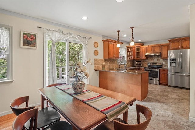 57 Wilner Rd, Somers, NY 10589 - kitchen featuring appliances with stainless steel finishes, under cabinet range hood, brown cabinetry, decorative backsplash, and recessed lighting