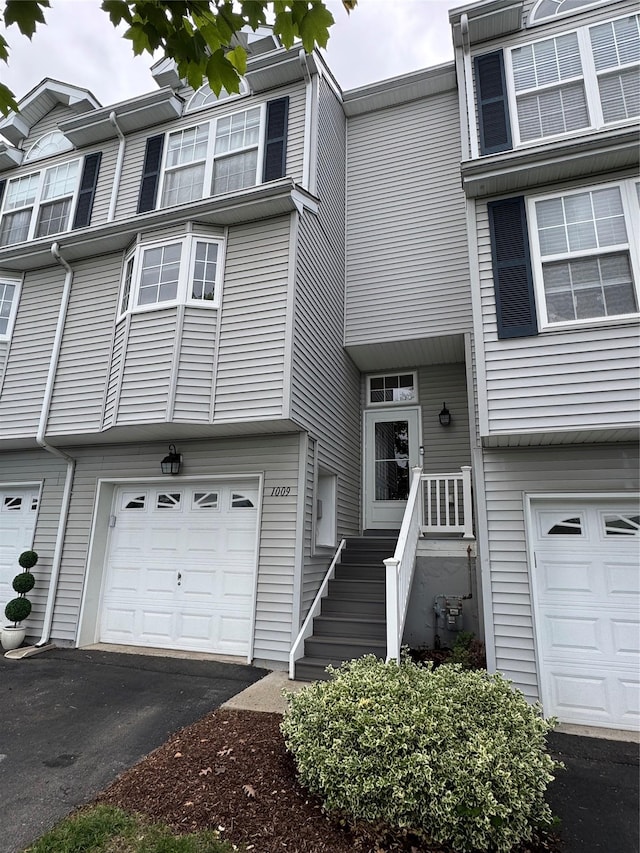 1009 Ethan Allen Dr Unit 1009, New Windsor, NY 12553 - townhome / multi-family property featuring an attached garage and asphalt driveway