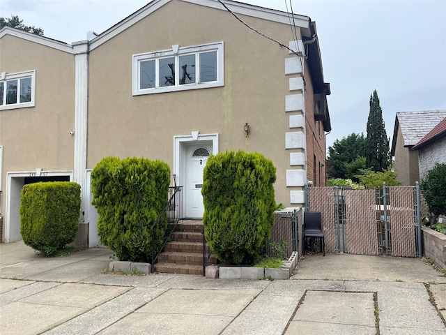 248-09 41st Ave, Little Neck, NY 11363 - view of front of property with a gate and stucco siding