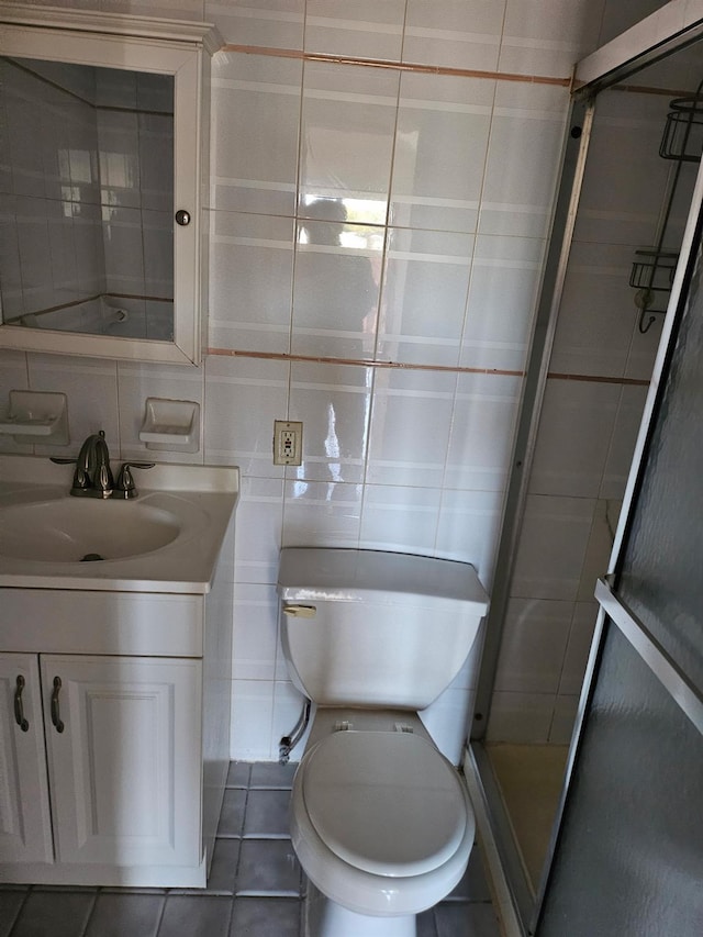248-09 41st Ave, Little Neck, NY 11363 - bathroom with vanity, tile patterned floors, a stall shower, tile walls, and toilet