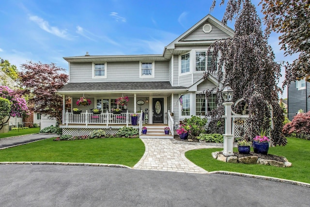 258 Timberpoint Rd, East Islip, NY 11730 - traditional-style house featuring covered porch and a front yard