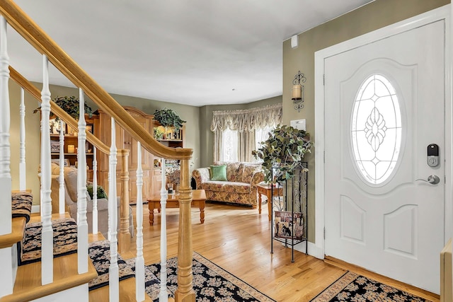 258 Timberpoint Rd, East Islip, NY 11730 - foyer entrance featuring light wood finished floors and stairs