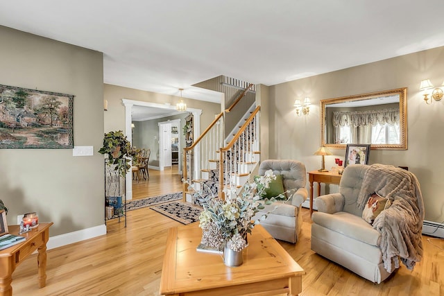 258 Timberpoint Rd, East Islip, NY 11730 - living area featuring light wood-type flooring, stairs, baseboards, and baseboard heating