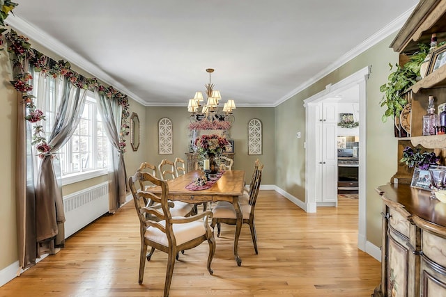 258 Timberpoint Rd, East Islip, NY 11730 - dining room with radiator heating unit, light wood-type flooring, a chandelier, crown molding, and baseboards