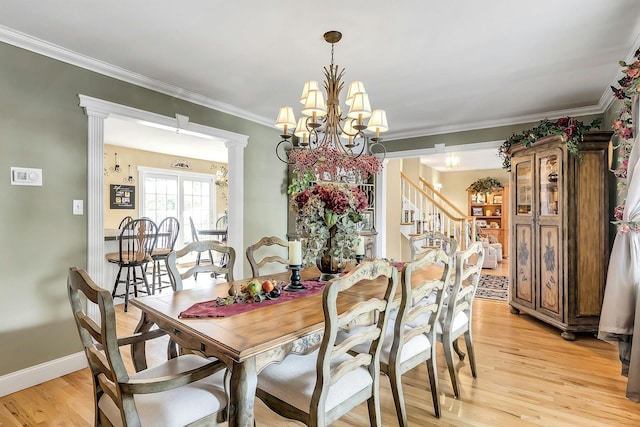 258 Timberpoint Rd, East Islip, NY 11730 - dining room with a chandelier, light wood-style floors, ornamental molding, baseboards, and stairway