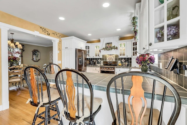 258 Timberpoint Rd, East Islip, NY 11730 - dining area featuring recessed lighting, light wood finished floors, ornamental molding, and a chandelier