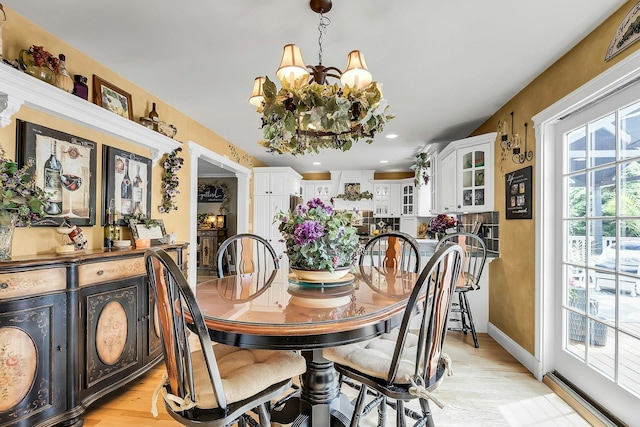 258 Timberpoint Rd, East Islip, NY 11730 - dining room with a chandelier, light wood-style floors, recessed lighting, and baseboards