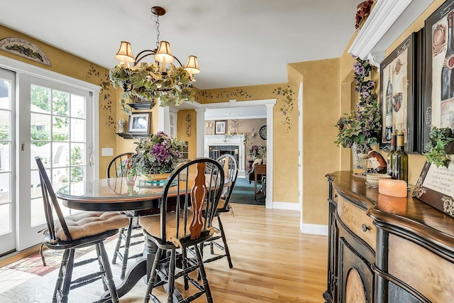 258 Timberpoint Rd, East Islip, NY 11730 - dining space featuring a chandelier, light wood finished floors, and baseboards