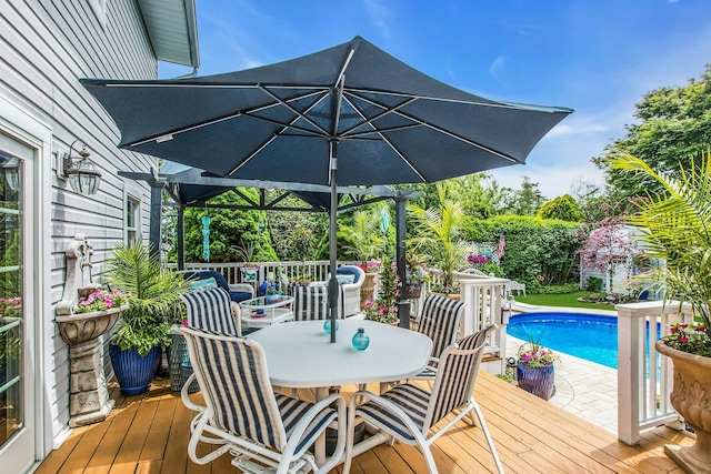 258 Timberpoint Rd, East Islip, NY 11730 - wooden deck with outdoor dining space and an outdoor pool