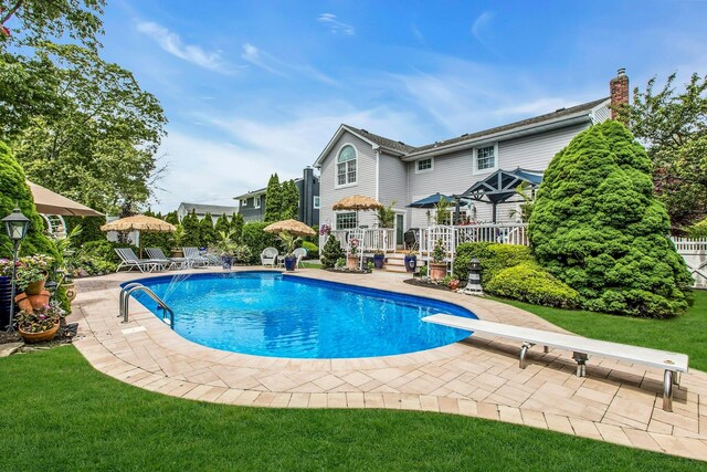 258 Timberpoint Rd, East Islip, NY 11730 - outdoor pool featuring a wooden deck, a patio, and a diving board