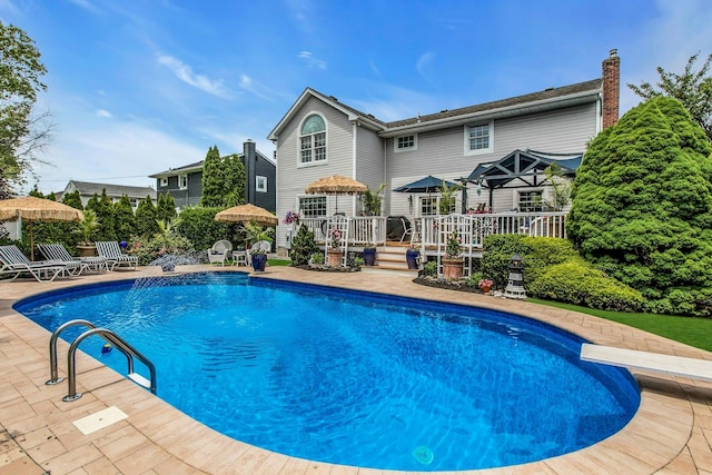258 Timberpoint Rd, East Islip, NY 11730 - swimming pool featuring a wooden deck, a diving board, and a patio area