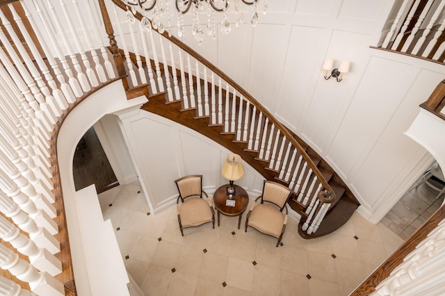 24 The Pnes, Old Westbury, NY 11568 - stairway with a decorative wall, arched walkways, tile patterned floors, and a chandelier