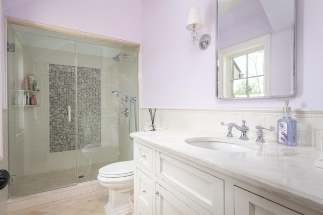 24 The Pnes, Old Westbury, NY 11568 - bathroom with vanity, toilet, a shower stall, wainscoting, and tile patterned floors