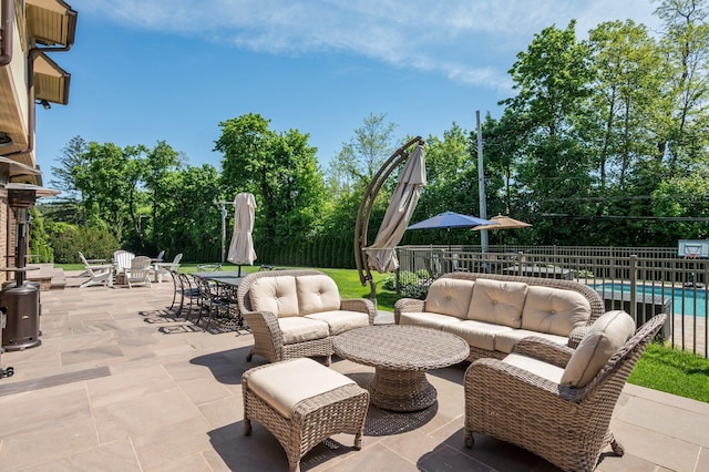 24 The Pnes, Old Westbury, NY 11568 - view of patio / terrace featuring an outdoor living space, outdoor dining area, and view of wooded area