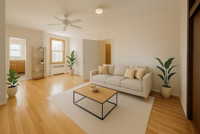 347 Graham Ave, Brooklyn, NY 11211 - living room with radiator heating unit, baseboards, light wood-type flooring, and ceiling fan