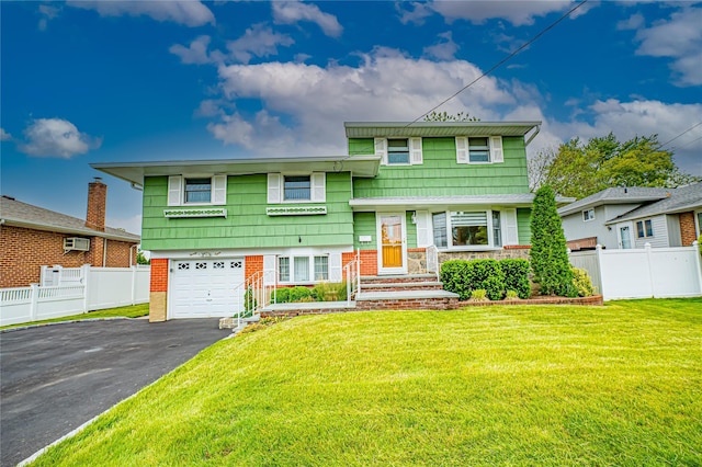 28 Chance St, Hicksville, NY 11801 - tri-level home featuring driveway, an attached garage, and a wall mounted air conditioner