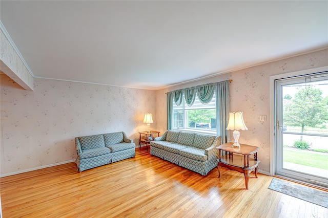 28 Chance St, Hicksville, NY 11801 - living room featuring light wood finished floors, wallpapered walls, baseboards, and crown molding
