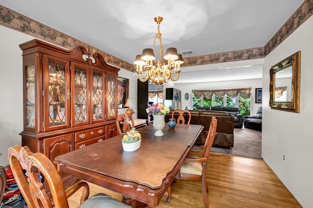 10 Catawba Dr, West Nyack, NY 10994 - dining area featuring a chandelier, light wood-type flooring, and baseboards