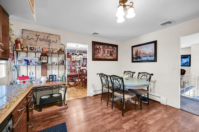 10 Catawba Dr, West Nyack, NY 10994 - dining area with a chandelier, wood finished floors, a baseboard heating unit, and baseboards