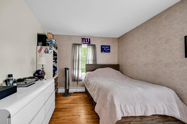 10 Catawba Dr, West Nyack, NY 10994 - bedroom featuring light wood-style floors, wallpapered walls, baseboard heating, and baseboards