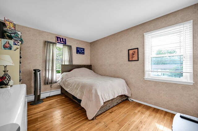 10 Catawba Dr, West Nyack, NY 10994 - bedroom with light wood-style floors, wallpapered walls, baseboard heating, and baseboards