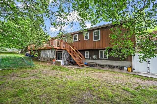 10 Catawba Dr, West Nyack, NY 10994 - rear view of house featuring stairway, a deck, and a lawn